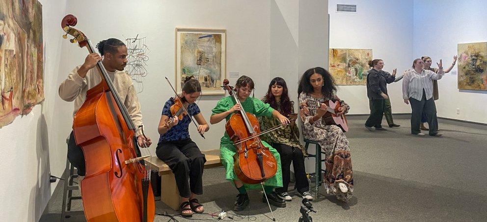 Ensemble Assemblage students playing music in the galleries 